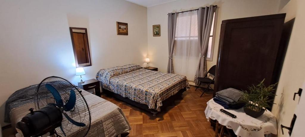 a hotel room with two beds and a window at Ñuñoa Sunrise B&B in Santiago