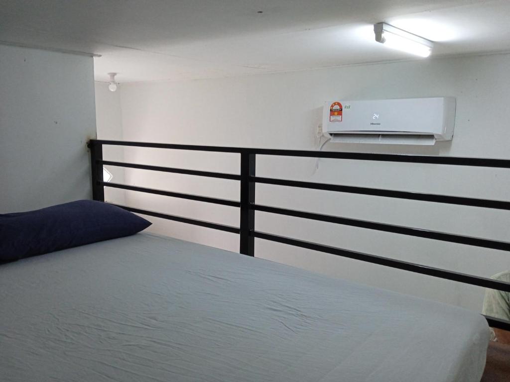 a bedroom with a bed and a black rail at Tiny House Idaman Kuala Terengganu with Private House in Kuala Terengganu