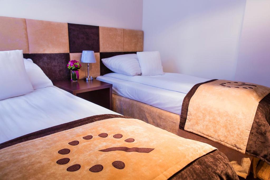 Postel nebo postele na pokoji v ubytování Boutique Hotel's III Piłsudskiego