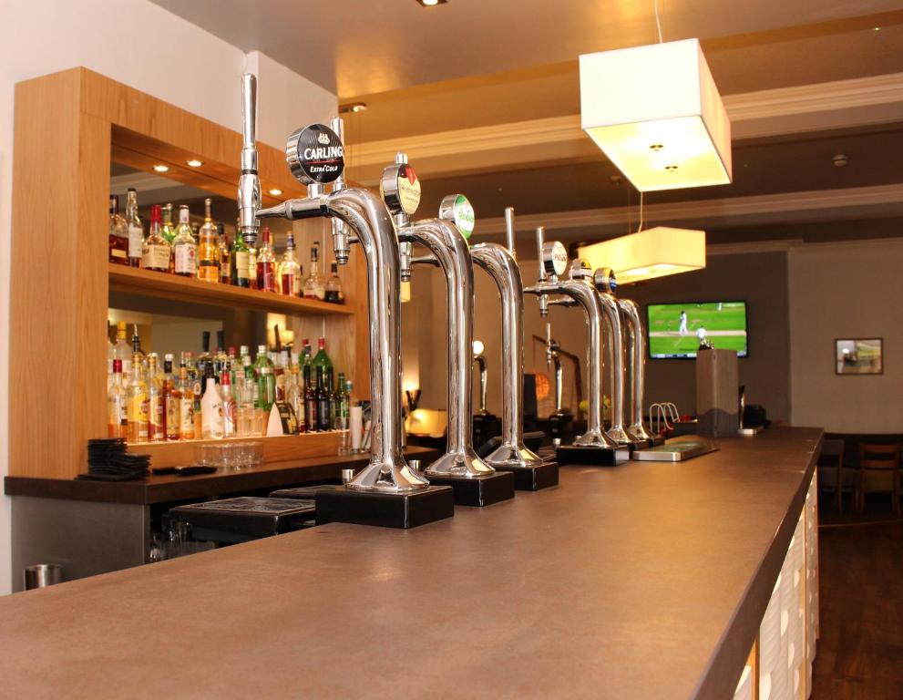 a bar with a row of alcohol bottles at The Cliff Hotel & Spa in Cardigan
