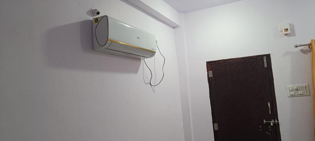 a room with a security camera on the wall at Mahalaxmi Guest House in Gokarna