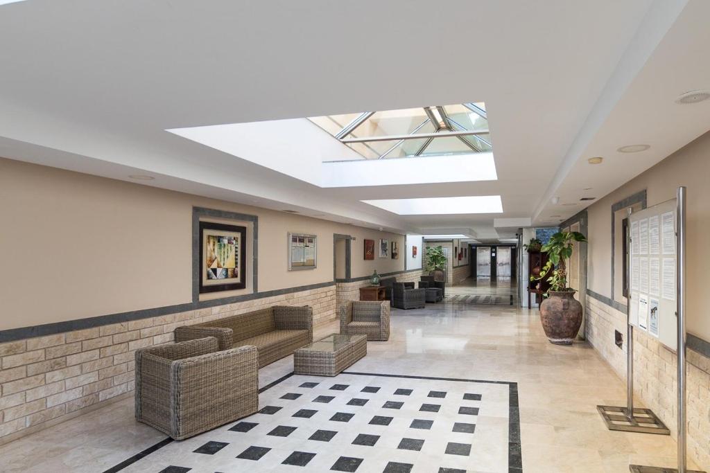 a lobby with couches and chairs in a building at Luxury House - Puerto Rico in Puerto Rico de Gran Canaria