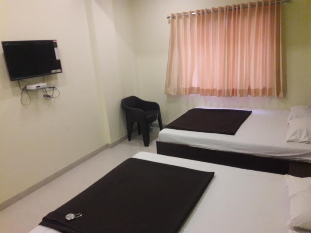 Postel nebo postele na pokoji v ubytování HOTEL SAI MEERA PALACE