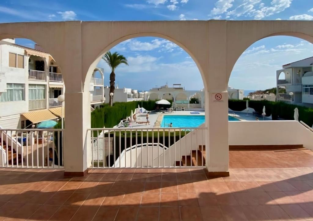 a view of the pool from the balcony of a resort at Casa Playa de la Mata in La Mata