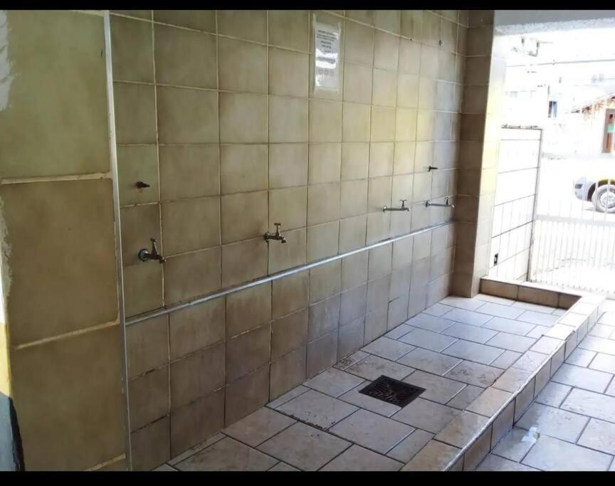a bathroom with a shower with a tiled floor at “Estúdio 116” - Espaço Gourmet próximo da praia. in Praia Grande