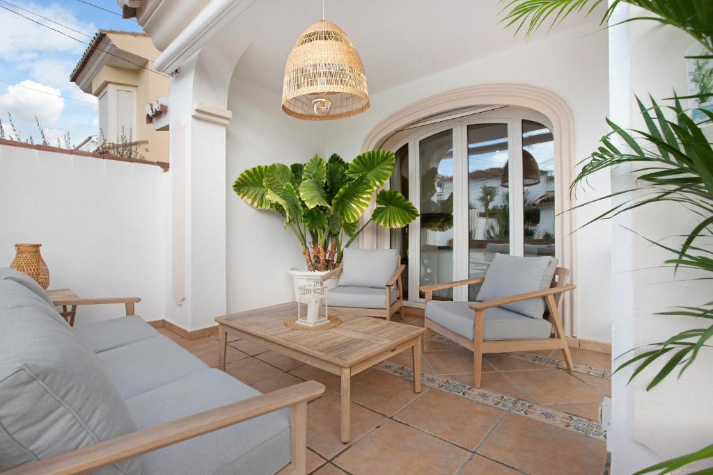 a patio with a couch and chairs and a table at La casita del mar in Torremolinos