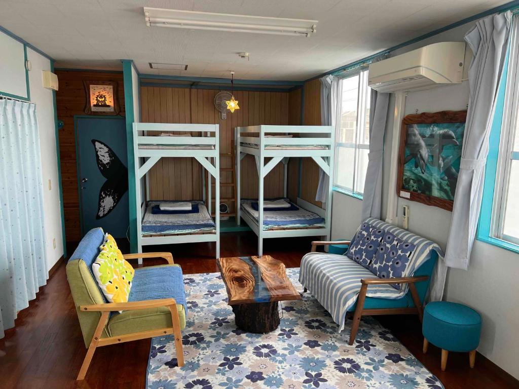 a living room with three bunk beds and a couch at Dolphins and Whales in Ishigaki Island