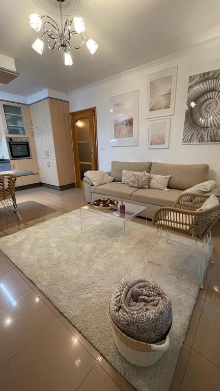 a living room with a couch and a table at Apartamento Saudade in Cambados
