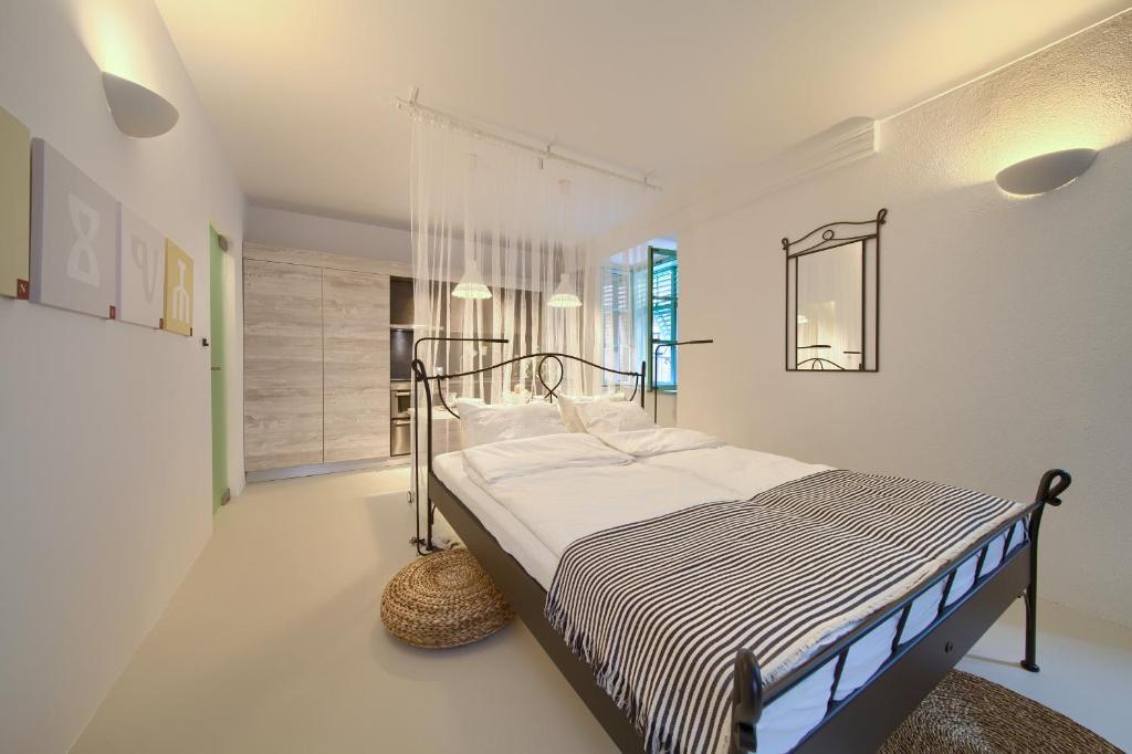 a bedroom with a bed in a white room at BASTINICA KRK Studio Ap 2, OldTown, CityCenter in Krk