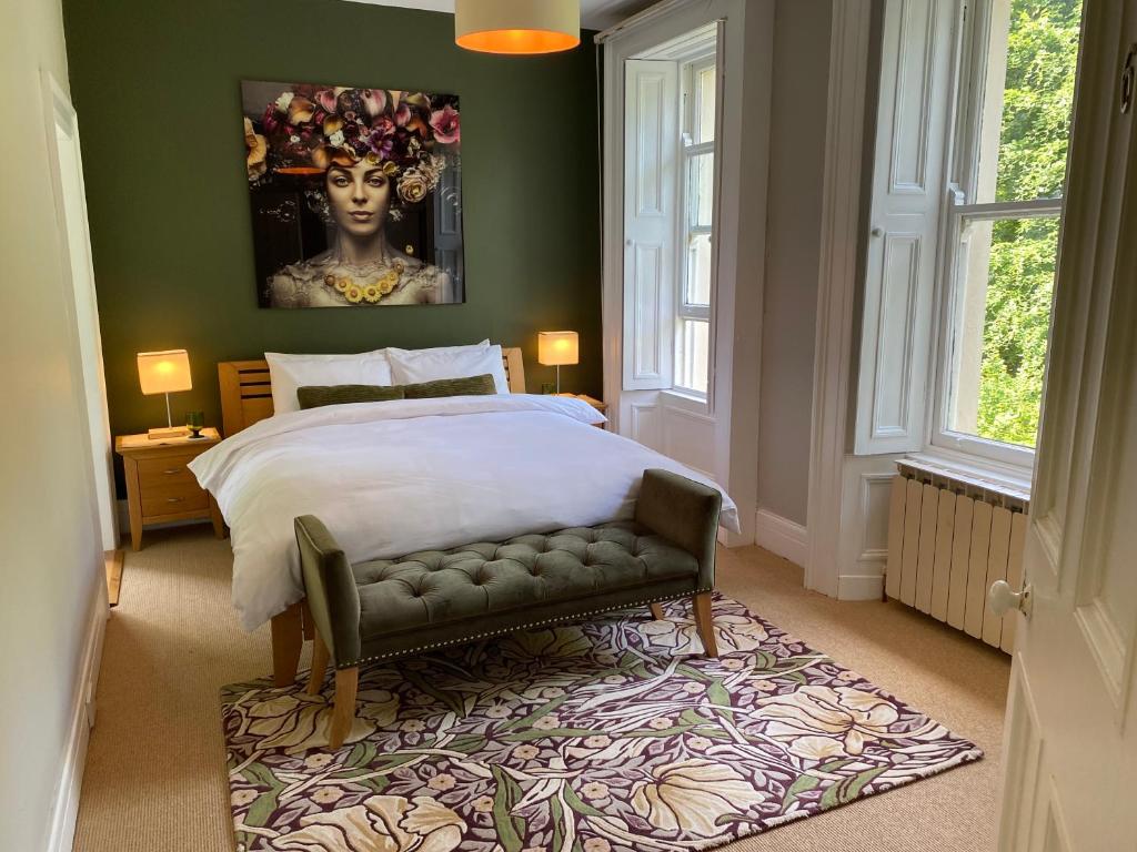 a bedroom with a king sized bed and a bench at Oakhurst Guesthouse in Cobh