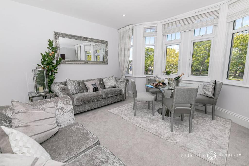 a living room with a couch and a table at Glamorous 2-bedroom, Central location, Scenic Views - Central Park Suite in Parkstone