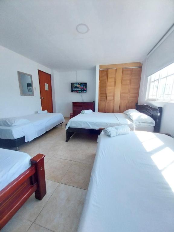 Postel nebo postele na pokoji v ubytování Hotel Sierra Nevada B&B SAS