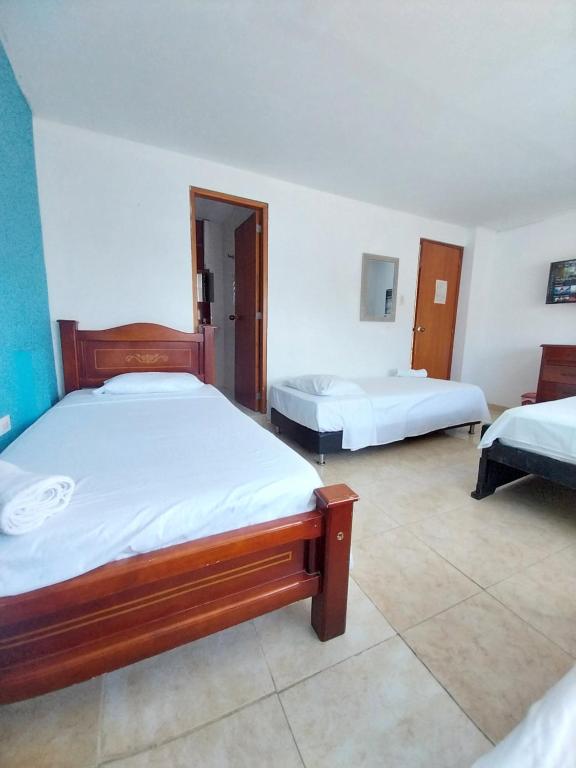 Postel nebo postele na pokoji v ubytování Hotel Sierra Nevada B&B SAS