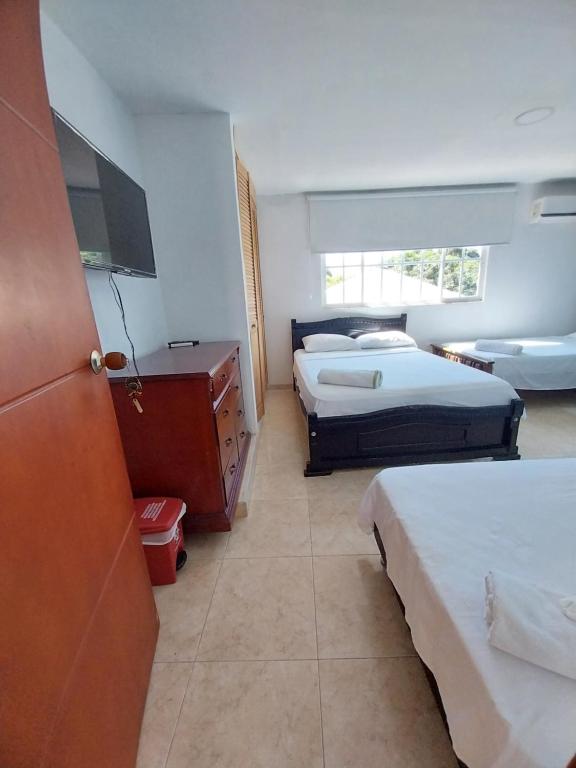 Postel nebo postele na pokoji v ubytování Hotel Sierra Nevada B&B SAS