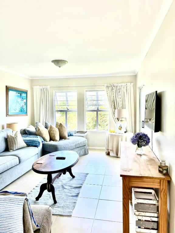a living room with a couch and a table at Elysian Retreat in Ballito