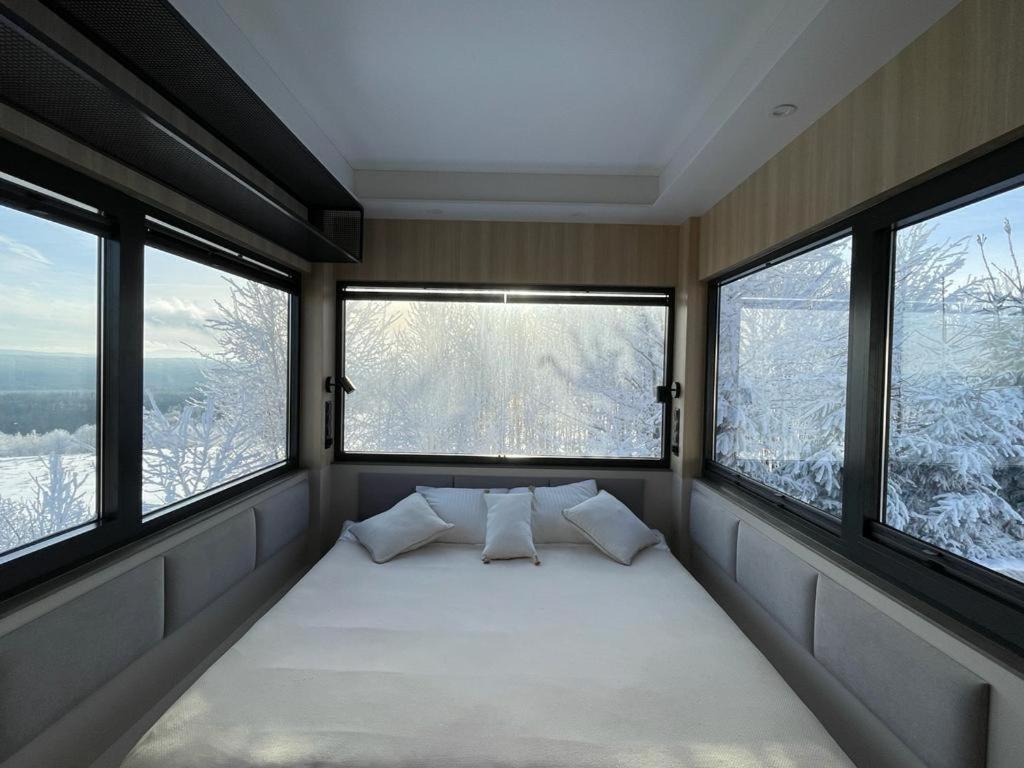 a bed in a room with three windows at Good Spot Zieleniec Twin Prestige 02 in Duszniki Zdrój