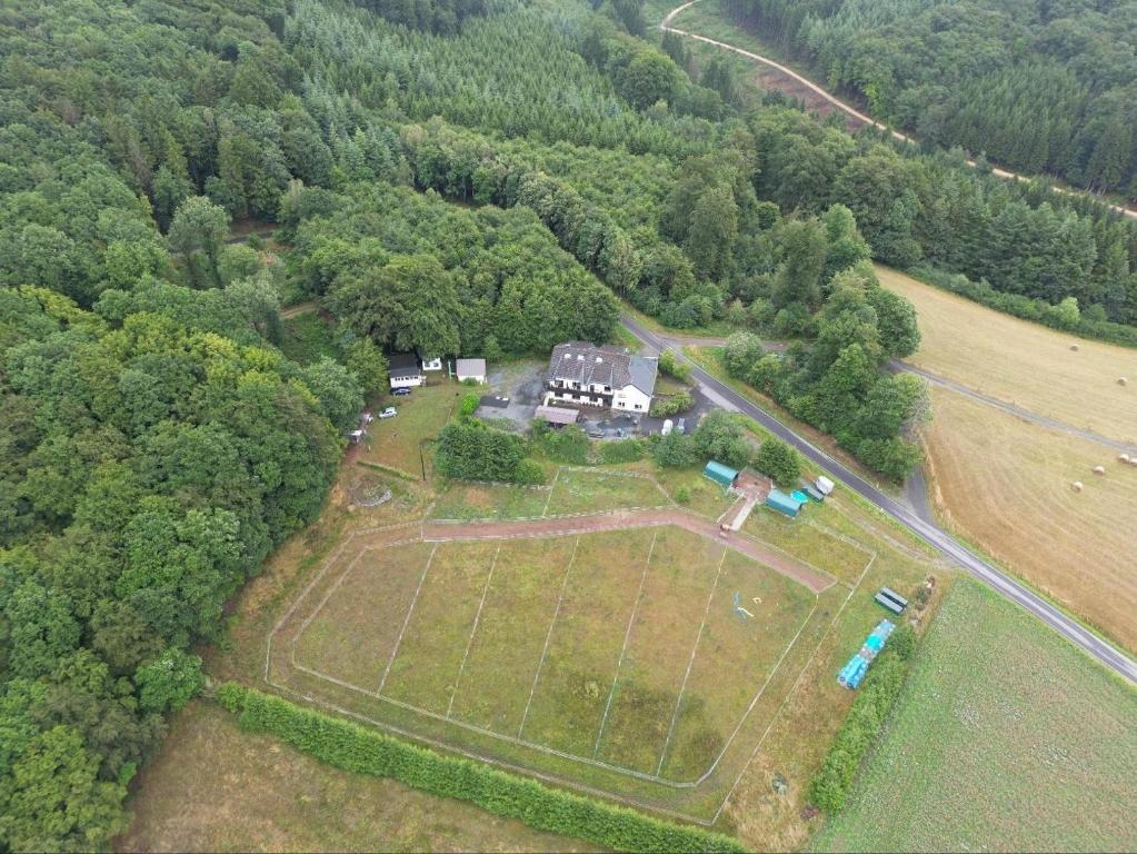 an aerial view of a large house in the forest at Haus Nirgendwo in Lützkampen