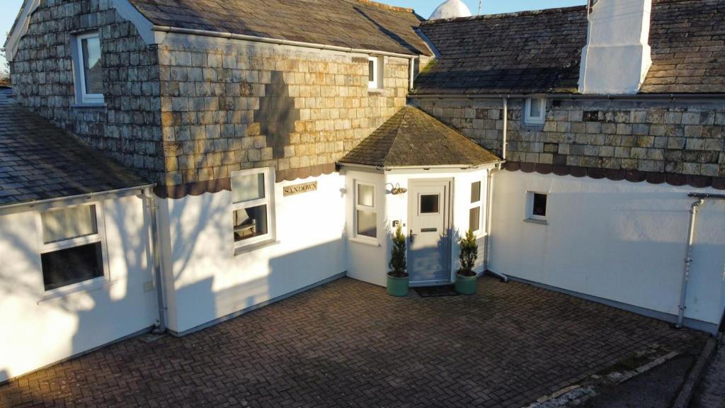 an aerial view of a white garage with a building at Sandown 4 bedroom house St Teath in Saint Teath