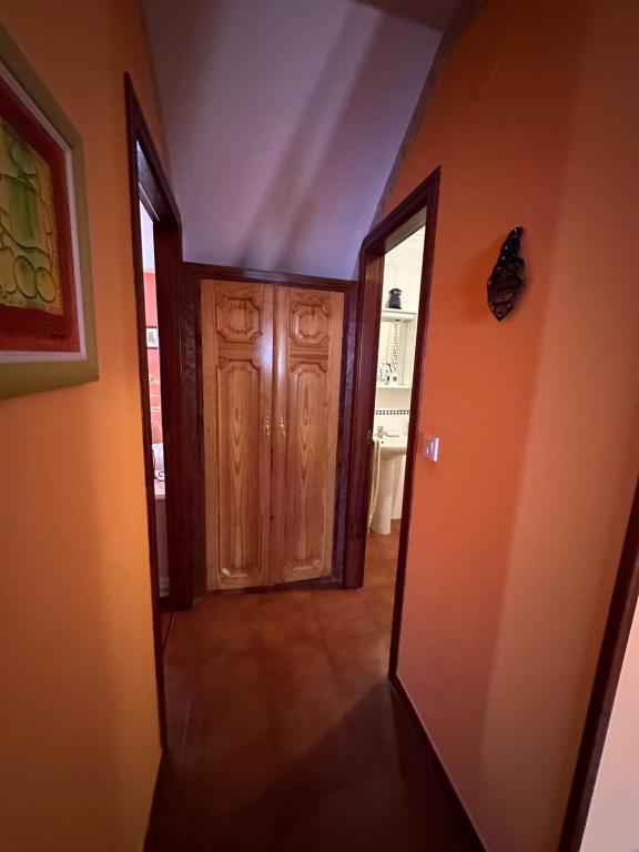 a hallway with a wooden door in a house at Apartamento Las Martas in Comillas