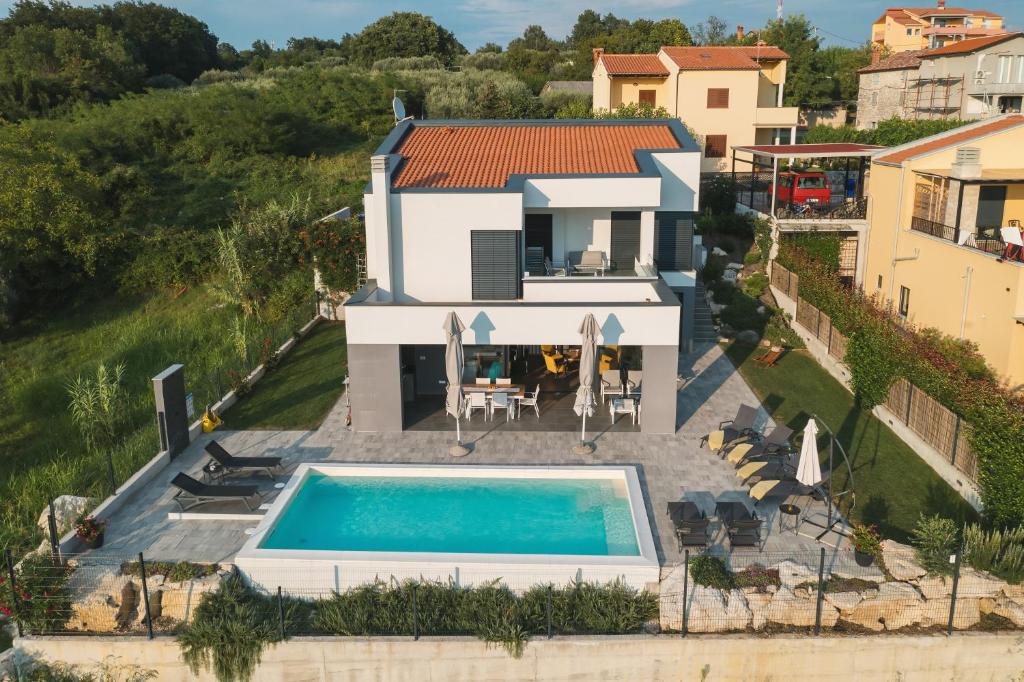 an aerial view of a house with a swimming pool at Villa Boiky - private pool and amazing sea view, Istria in Materada
