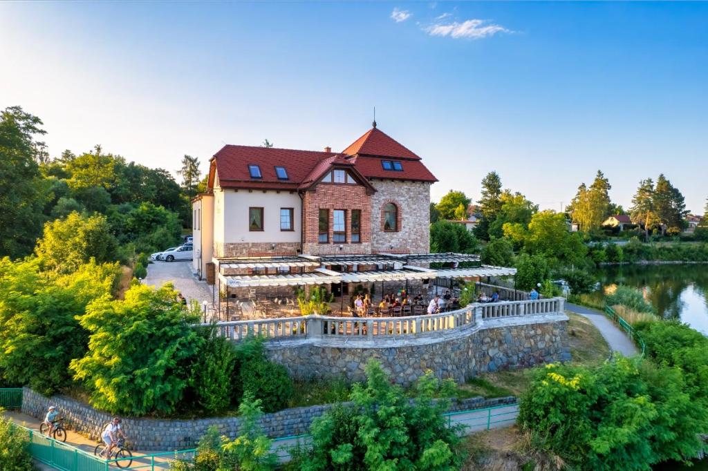 an aerial view of a building next to a river at Hotel Plumlov in Mostkovice