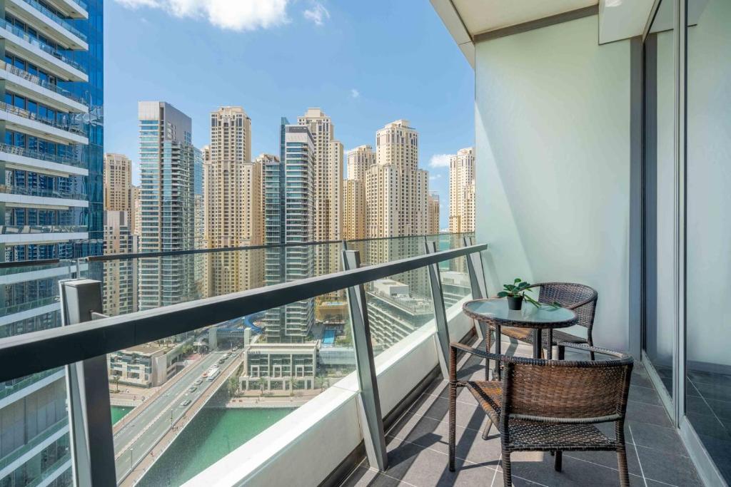 a balcony with a table and chairs and a view of a city at GuestReady - Studio | Balcony-Marina View in Dubai