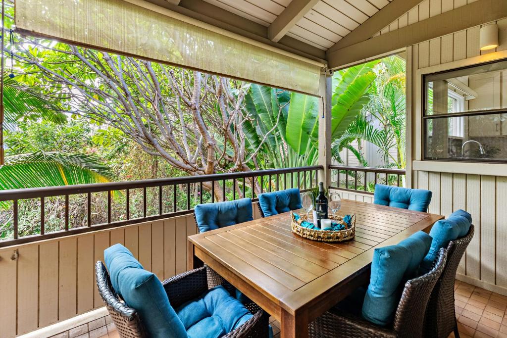 a porch with a wooden table and chairs at Ekolu 1602 in Wailea