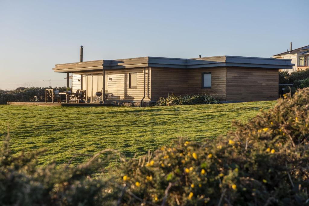 een huis op een heuvel met een grasveld bij Stargazy in St. Agnes 