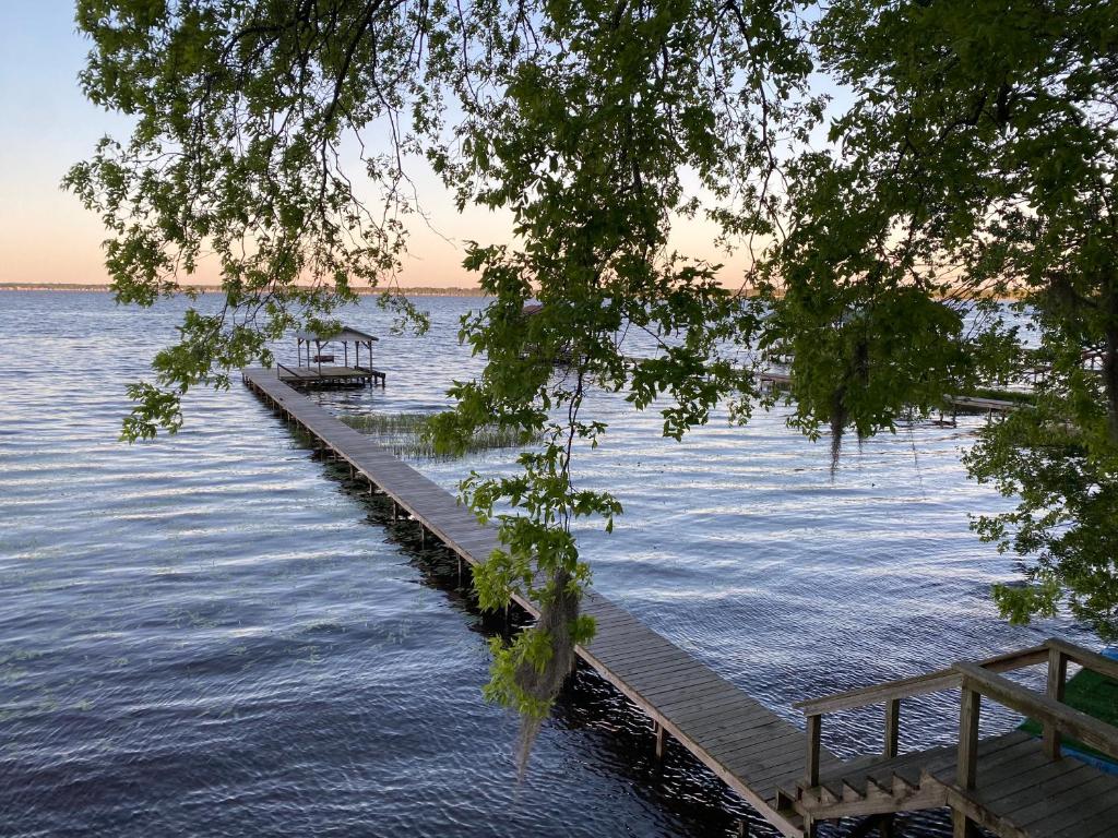 a dock in the middle of a body of water at Smooth Sailing on Lake Waccamaw in Lake Waccamaw