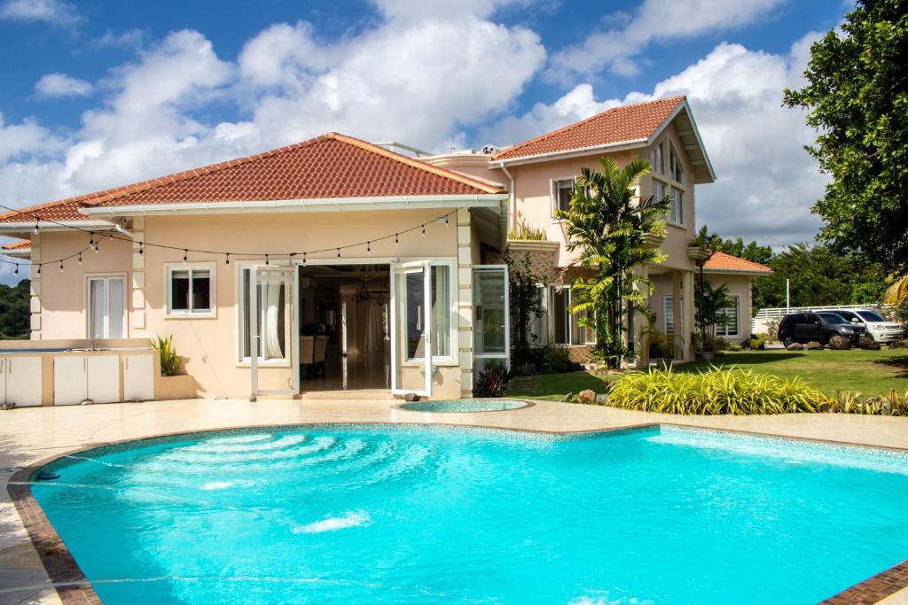 a swimming pool in front of a house at La Cresta in Kingstown