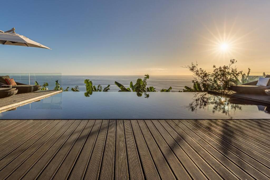 una piscina con vista sull'oceano sullo sfondo di The One Madeira a Ponta do Sol