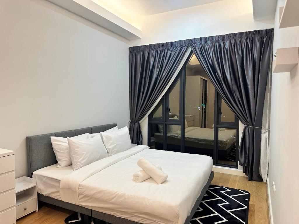 a bedroom with a bed and a large window at Sentral Luxury Suites KL in Kuala Lumpur