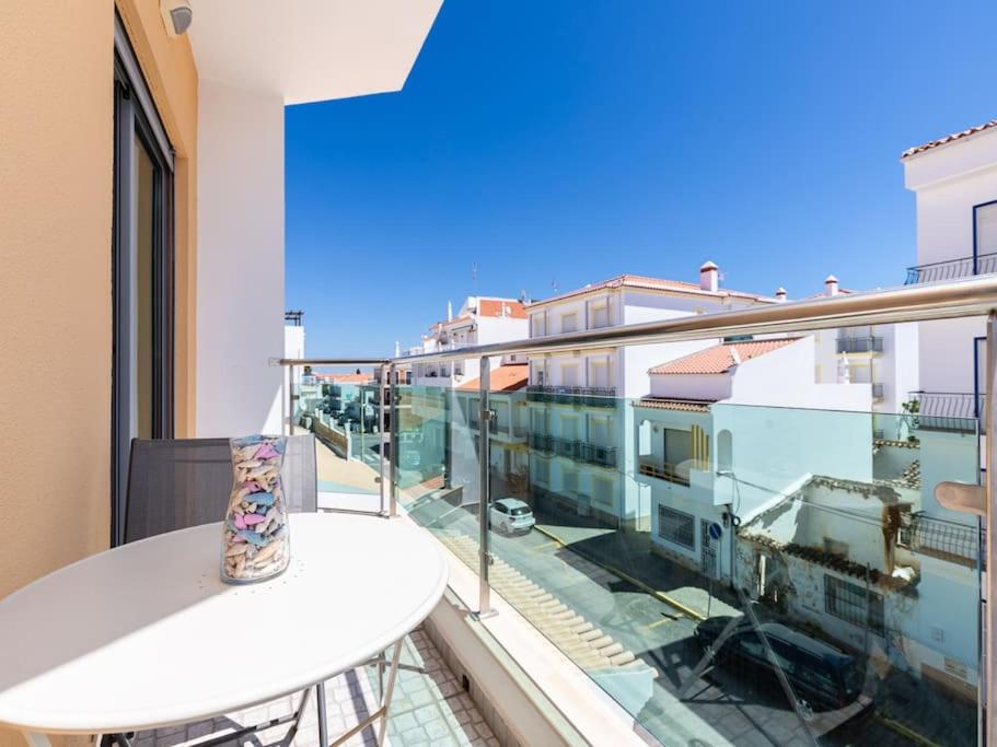 a balcony with a table and a view of a city at NEW!! 1 Bedroom Vila Nova de Cacela in Vila Nova de Cacela