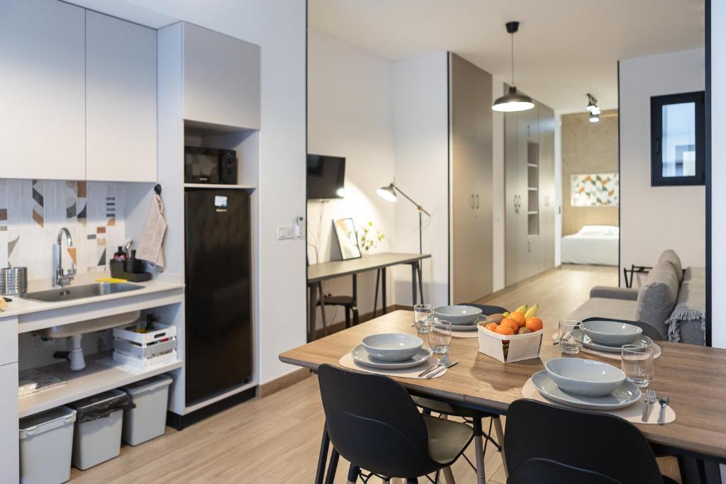 a kitchen and living room with a table and chairs at Victoria Inn Apartment in Valencia