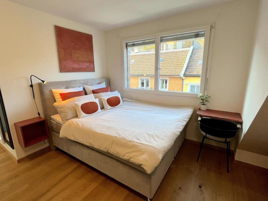 Schlafzimmer mit einem großen Bett und einem Fenster in der Unterkunft penthouse-studio centrally located in Zurich in Zürich