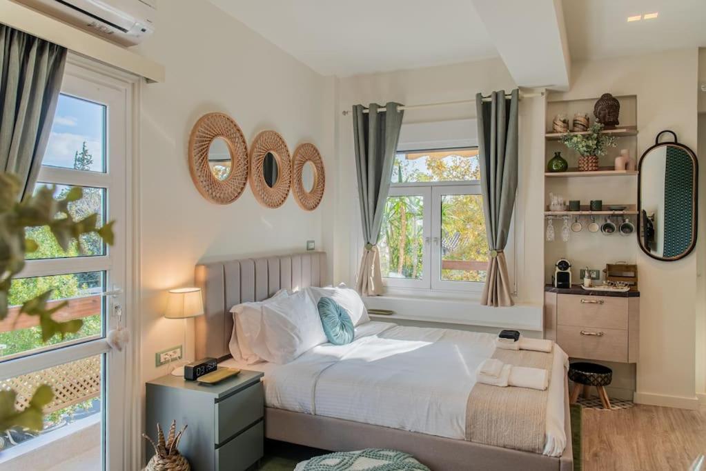 a bedroom with a bed and two windows at Central Kifissia LÍMε Malomar Homing in Athens