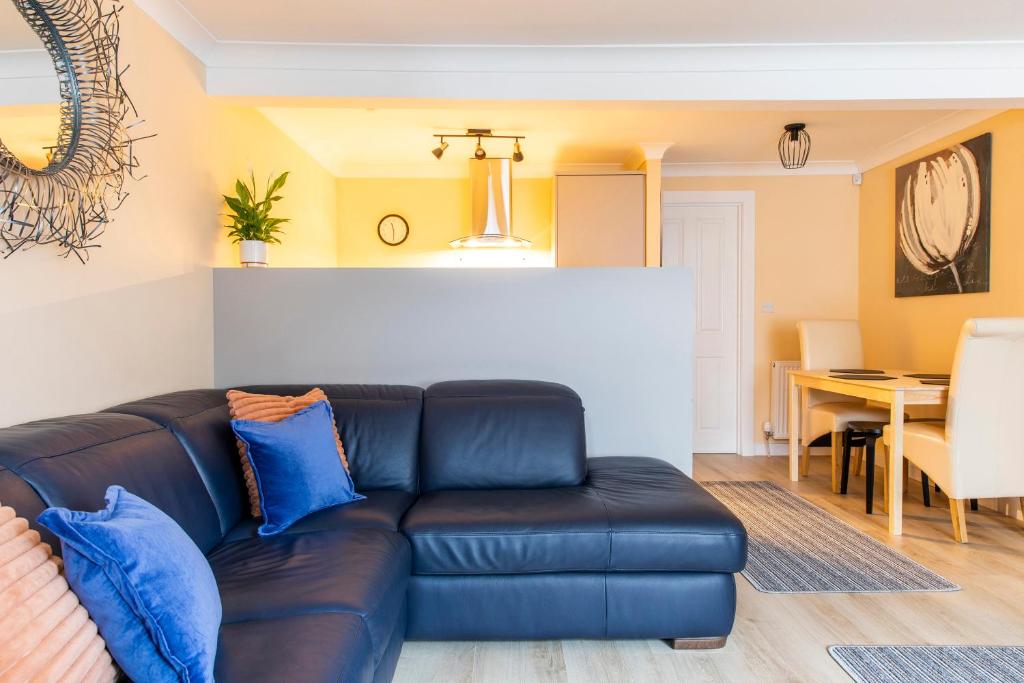 a living room with a couch and a dining room at The Apartment at No.12 in Lochwinnoch