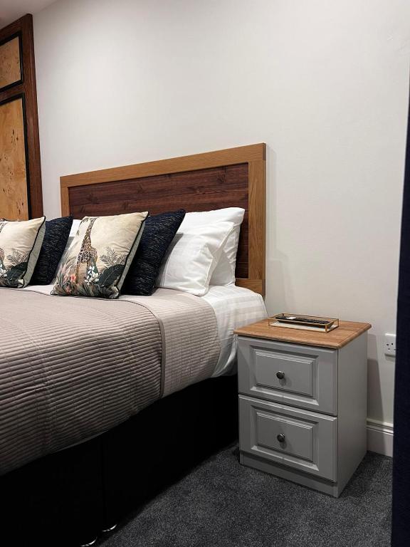 a bed with a wooden headboard and a night stand at B53 Accommodation in Maynooth