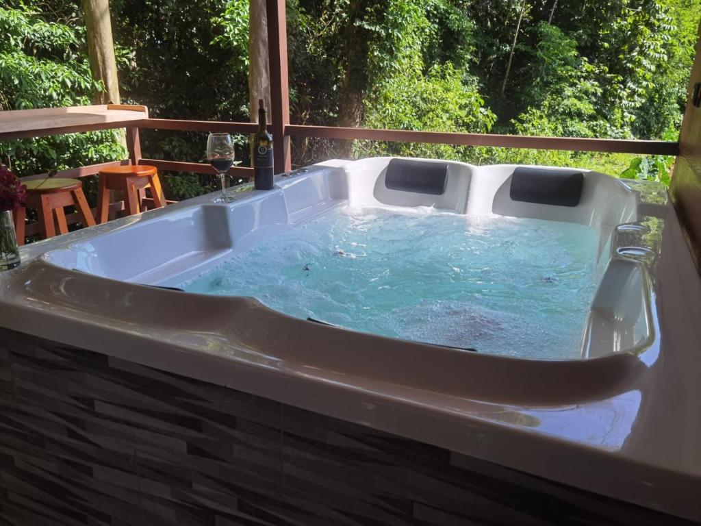 a jacuzzi tub on the deck of a house at Howler's House in Chachagua