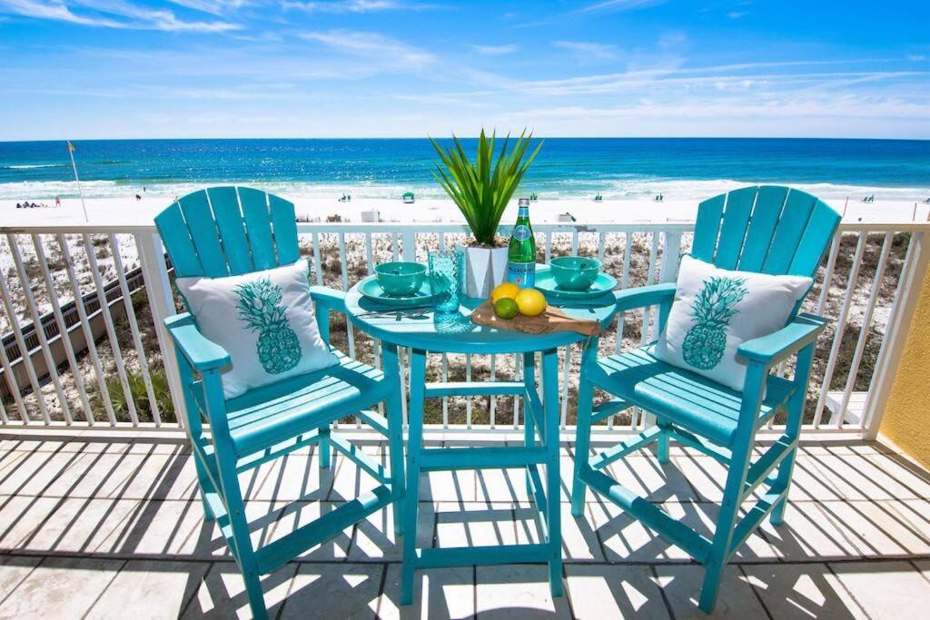a table and chairs on a balcony with the beach at Gulf Dunes 305 Coastal Dream in Fort Walton Beach