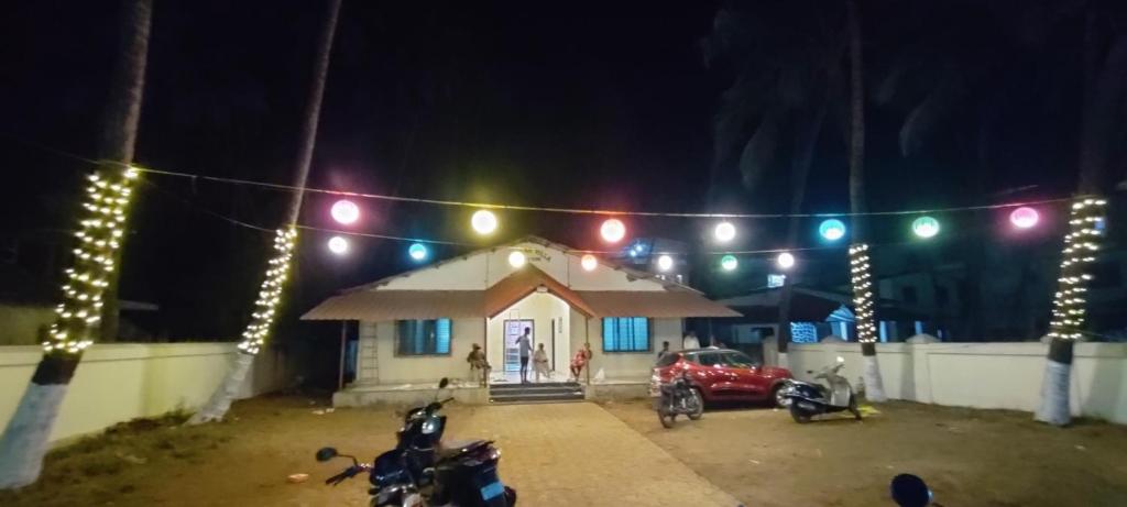 a small house with christmas lights in front of it at Hotel Seaview in Murud