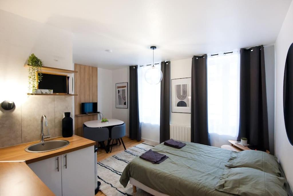 - une chambre avec un lit, un lavabo et un bureau dans l'établissement La Casa : Logement en centre ville, Cathédrale, à Amiens