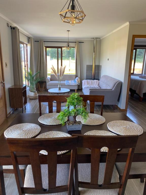 - un salon avec une table et des chaises dans l'établissement Refugio del bosque, à Futrono