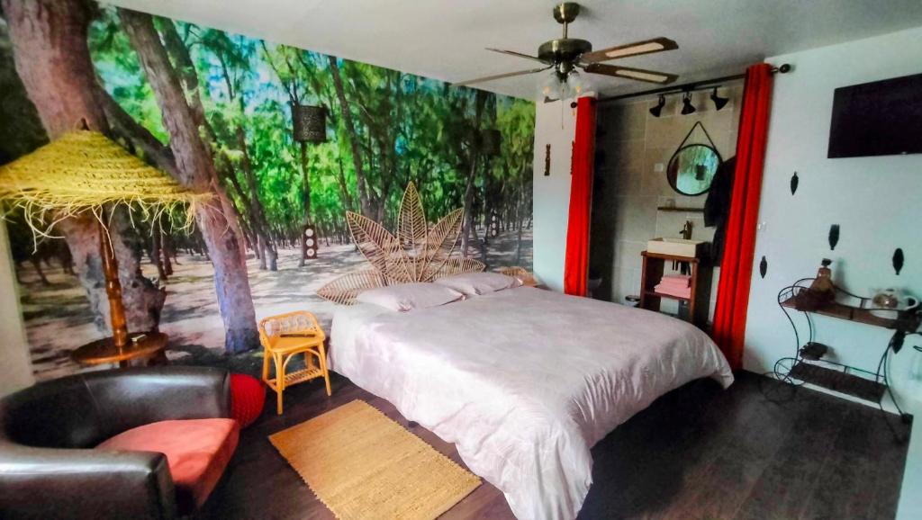 a bedroom with a large bed and a couch at Chez Aurélia - Chambres &amp; Table d&#39;hôtes in La Couture-Boussey