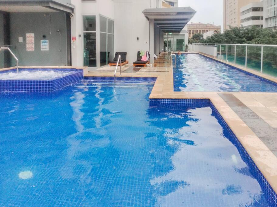 a large blue swimming pool on top of a building at Location! Inner City 1B1B Apt w/Pool,Gym, Sauna in Brisbane