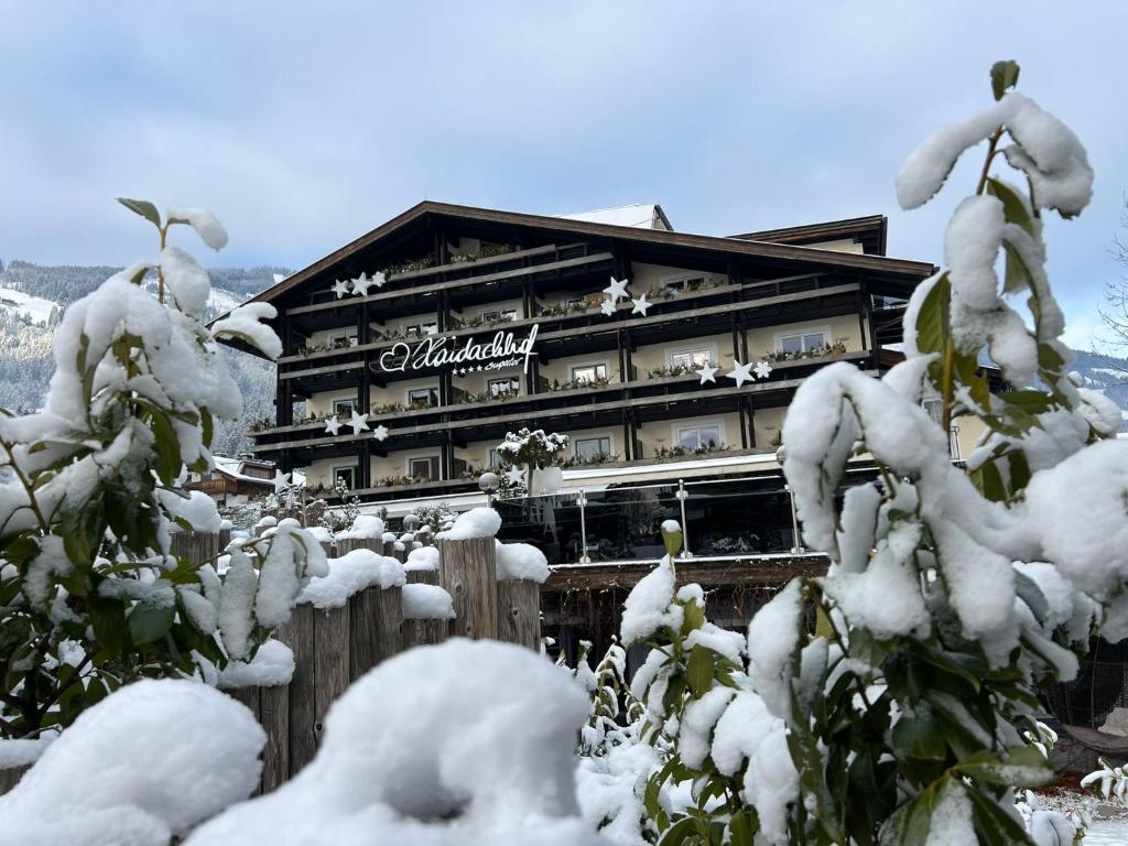 a building covered in snow in front at Boutique Hotel Haidachhof superior in Fügen
