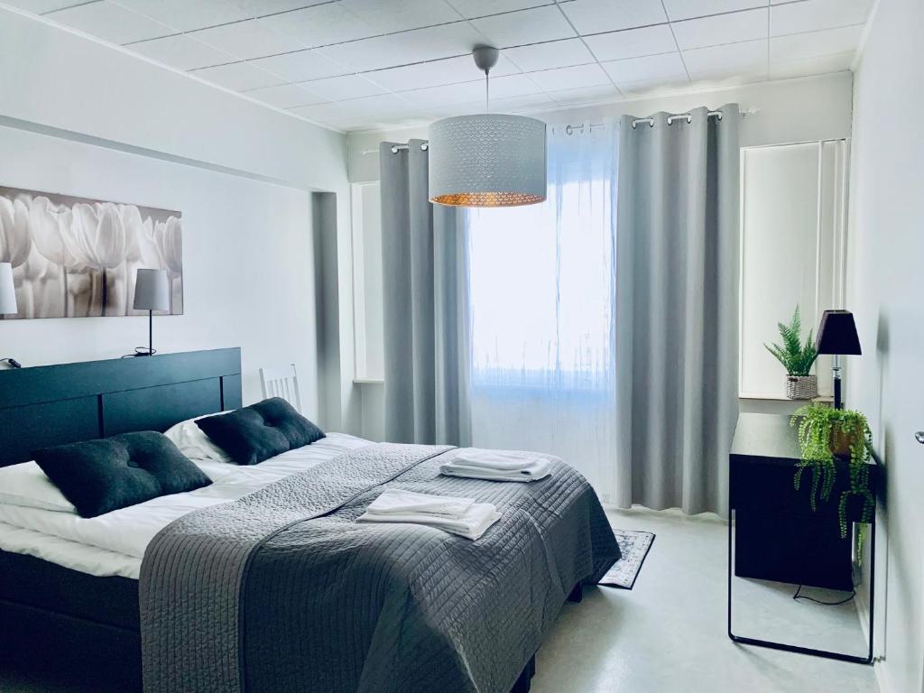 a bedroom with a bed and a large window at Kotimaailma Pori City in Pori