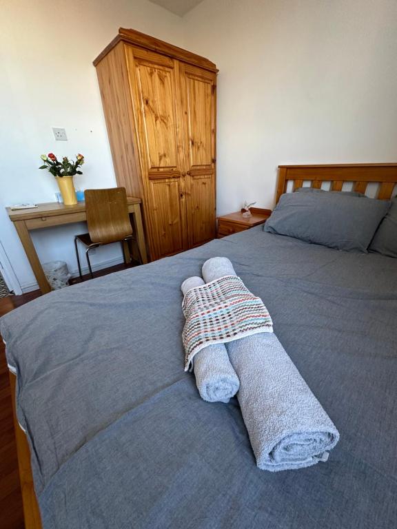ein Schlafzimmer mit einem Bett mit zwei Handtüchern darauf in der Unterkunft Elkington Point in London