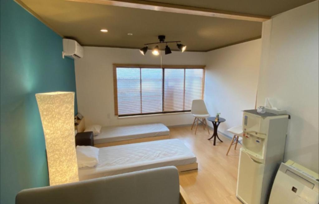 a living room with a couch and a window at Maison de Sato - Vacation STAY 16105 in Nabegayato
