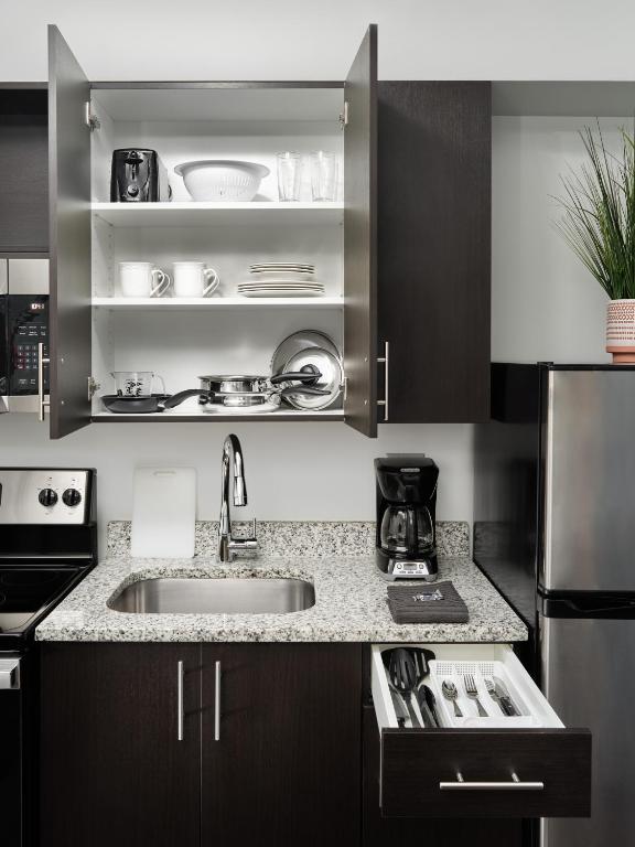 a kitchen with a sink and a counter at stayAPT Suites Killeen-Fort Cavazos in Killeen